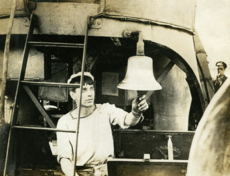 Sailor ringing new bell of HMS Broke, WW1